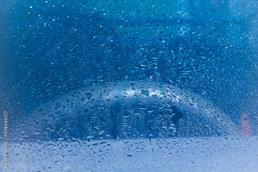 Fototapeta premium Water rain drops blue Vintage on glass wall on car rain drops on clear window or rain droplets on glass Of Raindrops Or Vapor Trough Window Glass Water droplets blue and Rain droplets 
