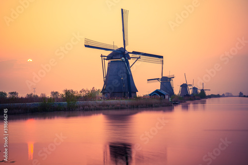 Traditional Dutch windmill at sunset in Kinderdijk. Netherlands 