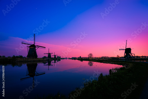 Silhouette of traditional Dutch windmills at dusk in Kinderdijk. Netherlands 