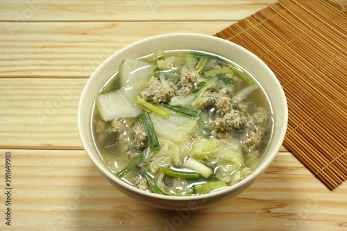 Clear soup of cutting Chinese cabbage mixed with minced pork and fresh spring onion in the bowl. Famous traditional soup menu in Asia restaurant.
