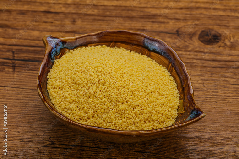 Raw cous cous heap in the bowl Raw cous cous heap in the bowl