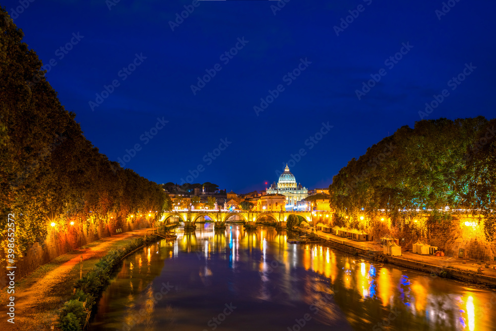 Sant' Angelo Bridge and St. Peter's cathedral at night in Vatican City, Rome.Italy