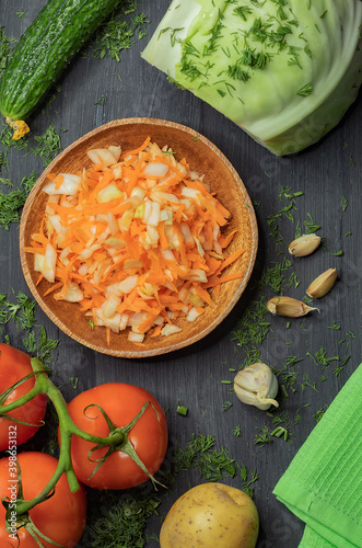 On the kitchen wooden table are ripe vegetables for cooking diet dishes