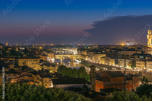 Night view of Florence city skyline with Arno River and Ponte Vecchio