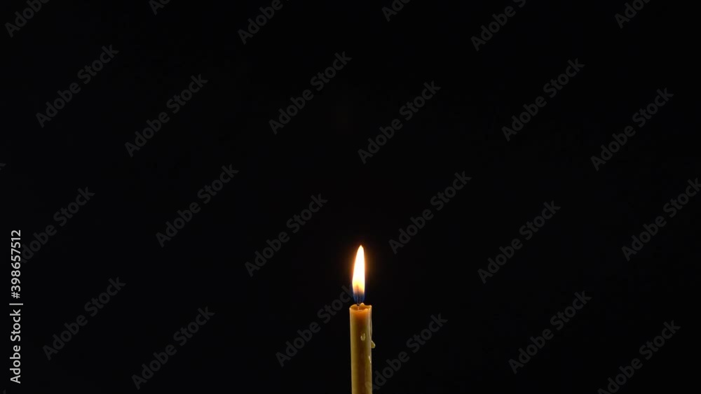 Wax candle blows out. Black dramatic background. Wax candle blows out. Black dramatic background.