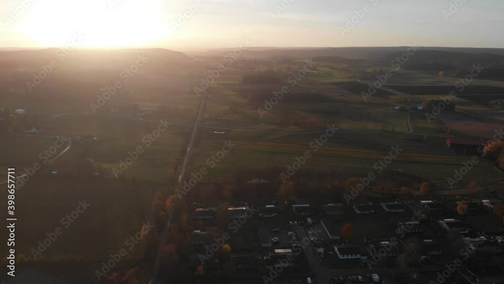 Vast Farm Land and Long Straight Road Outside Town, Sunset, Aerial Vast Farm Land and Long Straight Road Outside Town, Sunset, Aerial