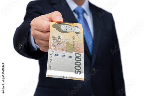 Businessman holding Korean currency in hand on white background.