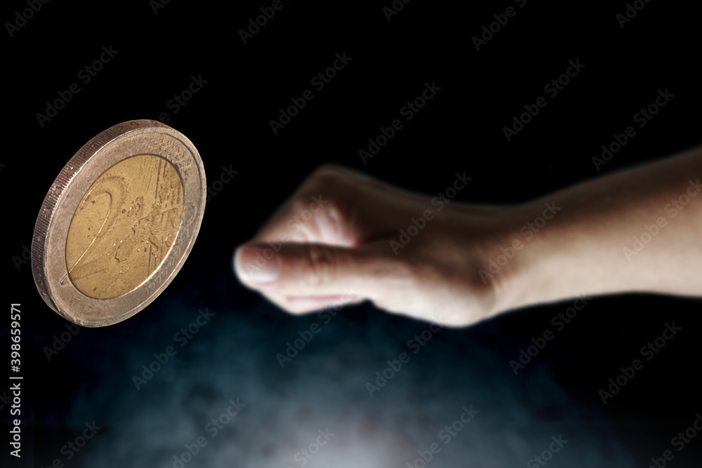 Fototapeta premium flips up a two euro coin, selective focus