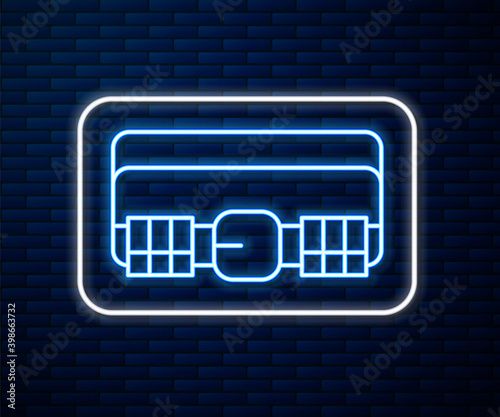 Glowing neon line Hunting cartridge belt with cartridges icon isolated on brick wall background. Bandolier sign. Hunter equipment, armament.  Vector.