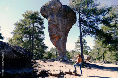 girl standing in front of a Rock formation called El Tormo Alto in the natural setting of the Enchanted City in Cuenca photo