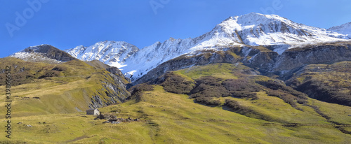 beautiful european alpine mountain wtih snowy peak background under blue sky