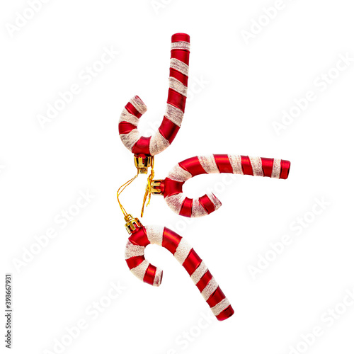 three red striped Santa Claus candies are stacked on a white background. To isolate the framing. Christmas toys for Christmas, New year, winter holiday atmosphere for lovers and loved ones