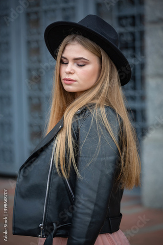 Girl in black hat posing on the street in the old city, copy space © hannamartysheva
