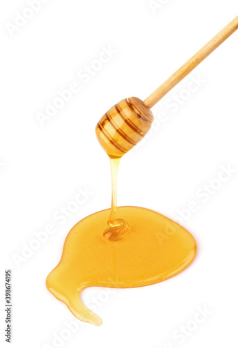 Honey stick with flowing honey isolated on white background