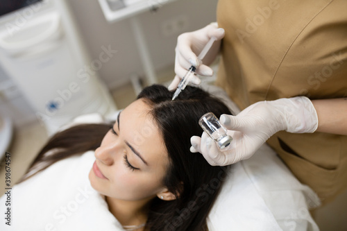 Young beautiful woman in spa salon on the procedure of mesotherapy.treatment of hair loss, injection for hair growth.