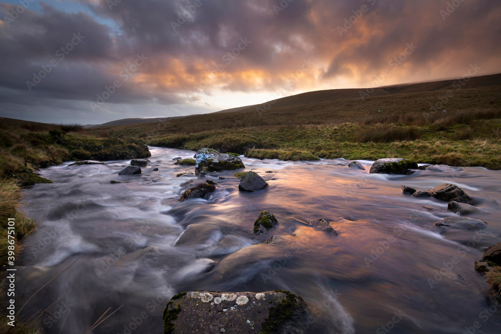Sunset over the Brecon Beacons and the river Tawe in South Wales UK
