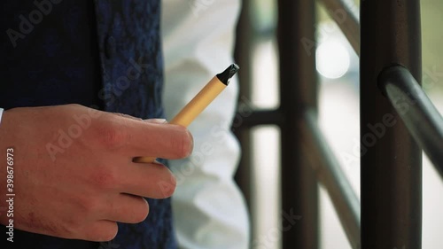 Electronic cigarette in the hands of a man close-up