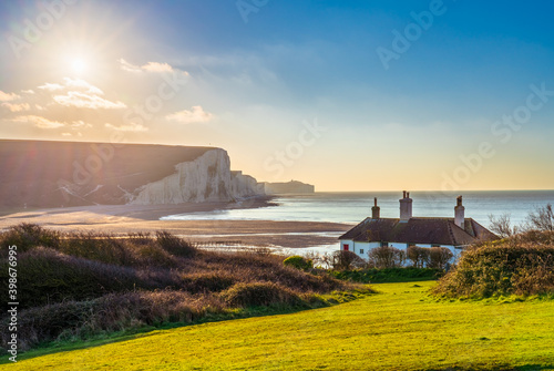 The Coast Guard Cottages & Seven Sisters Chalk Cliffs at sunrise in Sussex, England, UK