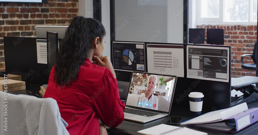 Caucasian woman on laptop video chat sitting at desk in office Caucasian woman on laptop video chat sitting at desk in office