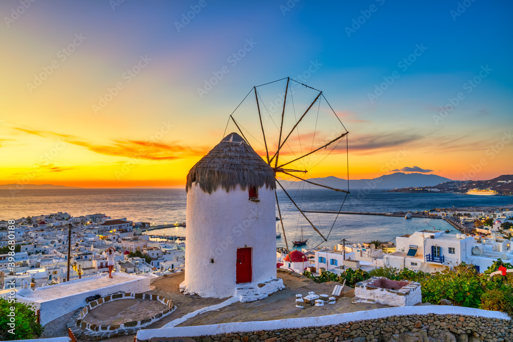 Naklejka premium Traditional Greek windmill at sunset in Mykonos island. Greece