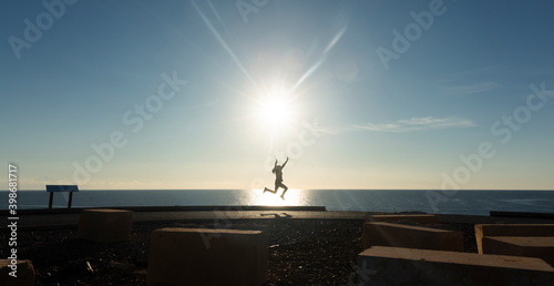 A woman jumping with arms outstretched
