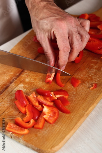 Chef slicing red bell pepper. Making Chicken and Egg Galette Series.