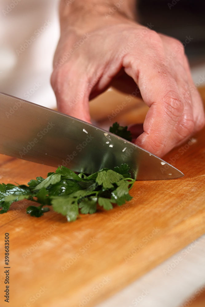 Chef slicing parsley. Making Chicken and Egg Galette Series. Chef slicing parsley. Making Chicken and Egg Galette Series.