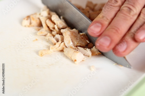 Cutting fried chicken fillet. Making Chicken and Egg Galette Series.
