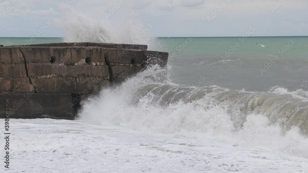Big Strong Waves Crash Into The Huge Rocks. Storm At Sea. Big Strong Waves Crash Into The Huge Rocks. Storm At Sea.