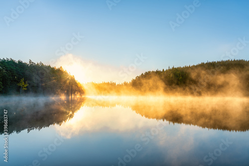 Fototapeta Naklejka Na Ścianę i Meble -  Sunrsise at the lake with morning fog