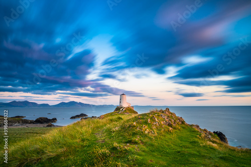 Lighthouse on Llanddwyn Island viewed at sunset. North Wales. UK