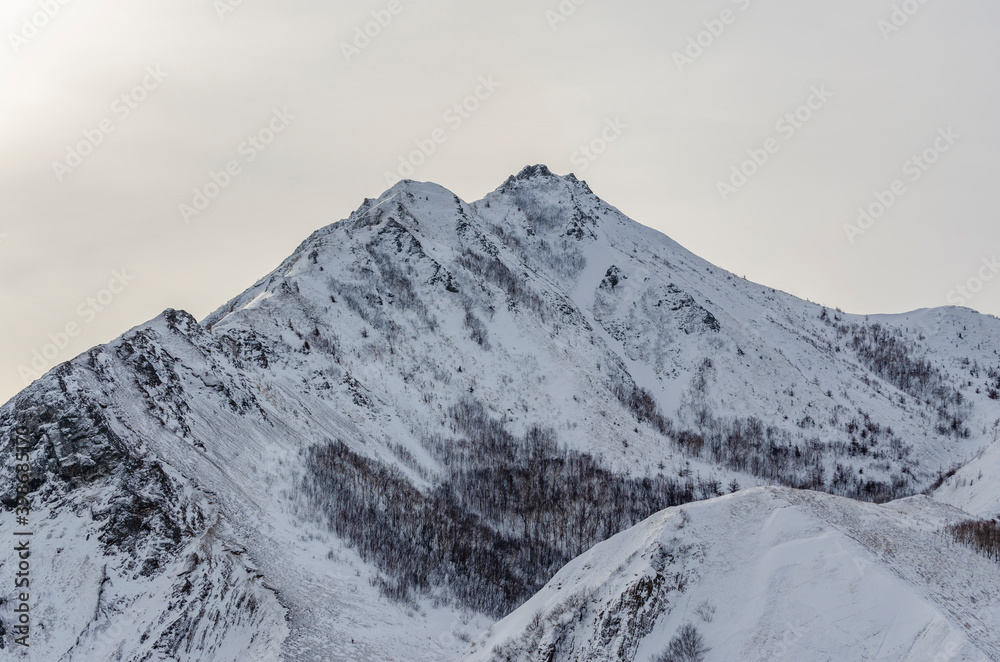 Double snow-capped mountain on the island of Sakhalin. Winter. The mountains. Snow.