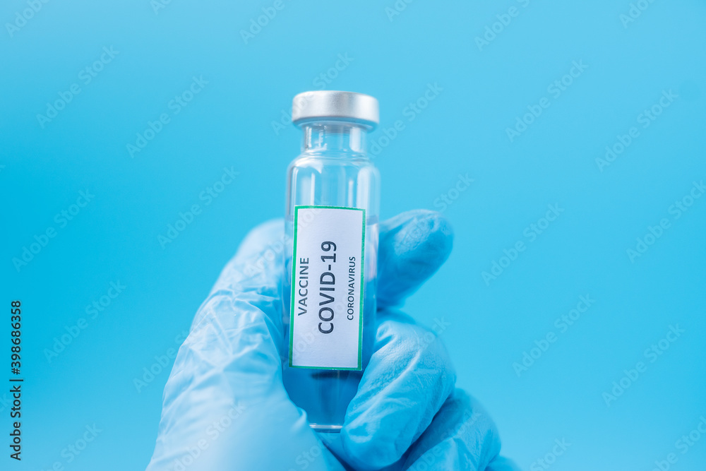 COVID-19 Vaccine vial against Coronavirus infection in hand of doctor with Nitrile Glove in hospital laboratory. Medical, health, Vaccination and immunization concept COVID-19 Vaccine vial against Coronavirus infection in hand of doctor with Nitrile Glove in hospital laboratory. Medical, health, Vaccination and immunization concept