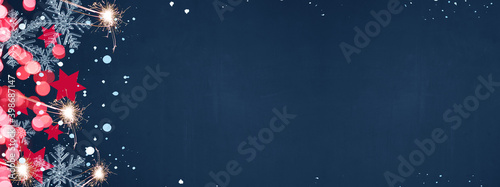 Christmas / Silvester / New Year background banner Panorama, card template - Red stars, ice crystals, snowy snowflakes, sparklers and bokeh, isolated on dark blue night texture	
