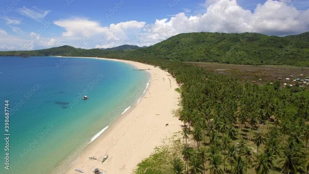 Aerial view of palm trees and turquoise ocean water at Nacpan Beach in El Nido, Palawan Island, Philippines. Aerial view of palm trees and turquoise ocean water at Nacpan Beach in El Nido, Palawan Island, Philippines.