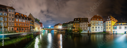 Strasbourg panorama of traditional half timbered houses near water canal at night. France