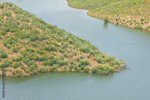 Top view of Monfrague national park in Spain. High mountains and hills covered in green with a river photo