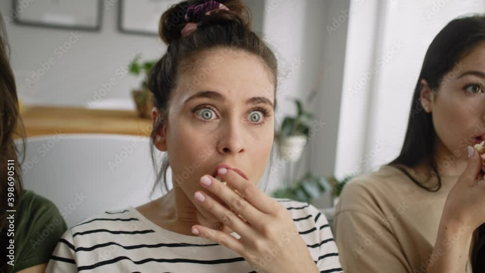 Tracking video of frightened friends watching a horror movie. Shot with RED helium camera in 8K. Tracking video of frightened friends watching a horror movie. Shot with RED helium camera in 8K.