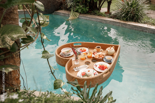 Heart shaped breakfast tray served in the swimming pool. Concept honeymoon vacation on Bali © Yevhenii