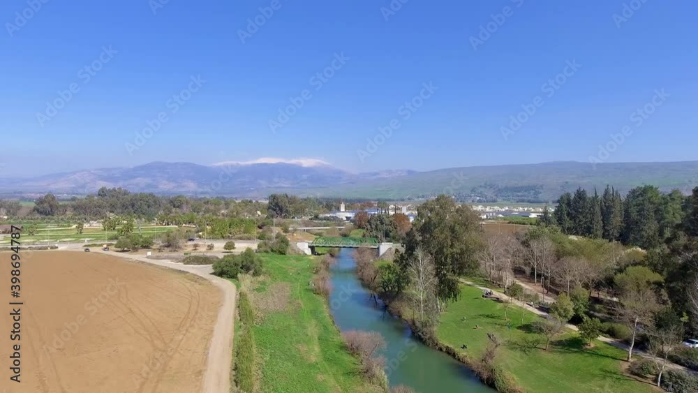 jordan river with hermon mountain in background from a drone view jordan river with hermon mountain in background from a drone view