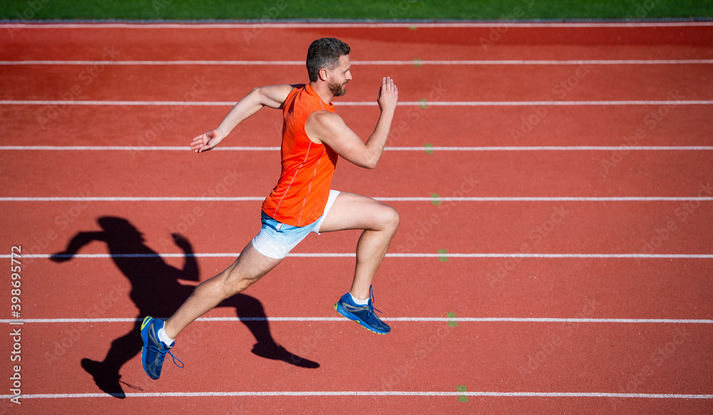 Fototapeta premium workout routine. challenge and competition. marathon speed. sport athlete run fast to win. successful fitness sprinter. male coach on stadium running track. endurance and stamina. runner on racetrack