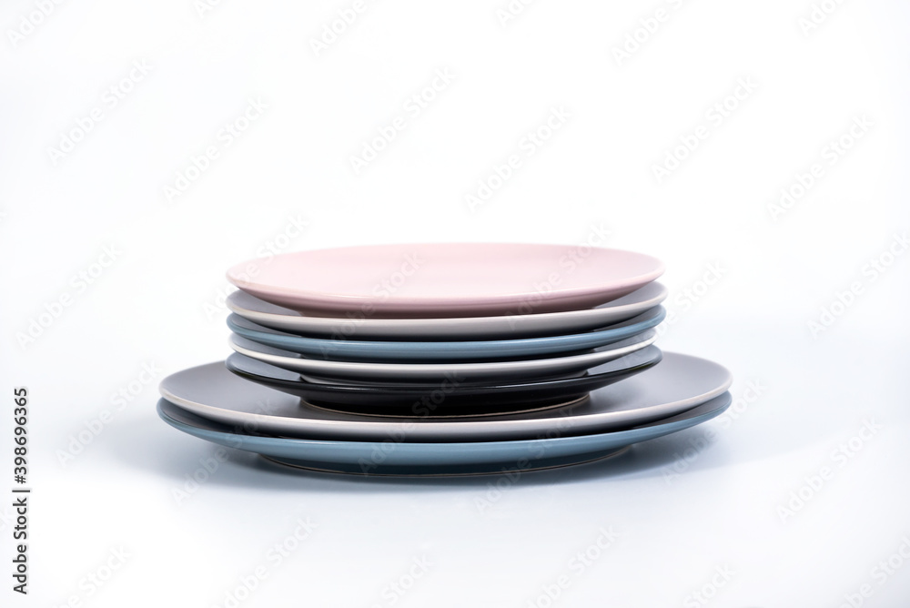 Stack of seven Large and Small colorful empty plates isolated on white background, side view. Navy Blue, Grey, Black, White, and Pink empty plates collection Stack of seven Large and Small colorful empty plates isolated on white background, side view. Navy Blue, Grey, Black, White, and Pink empty plates collection