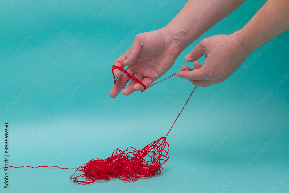 Unravel the tangle of threads and wind them around your hand.