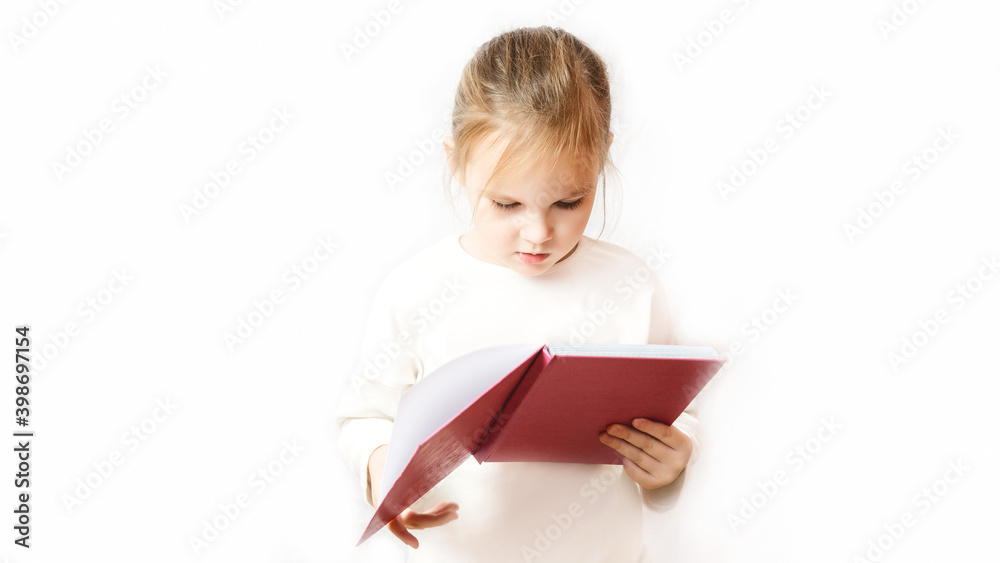 little girl reading a pink notebook on white background. learning concept little girl reading a pink notebook on white background. learning concept