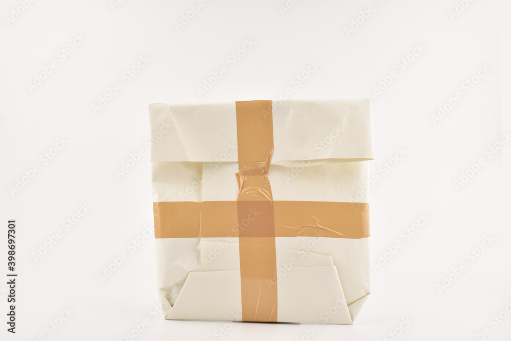 Obraz premium Taped packet isolated on white background, secure parcel