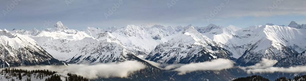 Dramatic snow covered mountains Landscape. Amazing Panoramic snowy winter landscape in Alps at sunrise morning. View from Riedberger Horn Grasgehren Ski Resort to Allgau Alps, Bavaria, Germany.