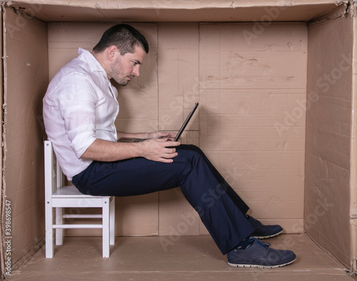 broken businessman in a cardboard office, stress and depression from overwork