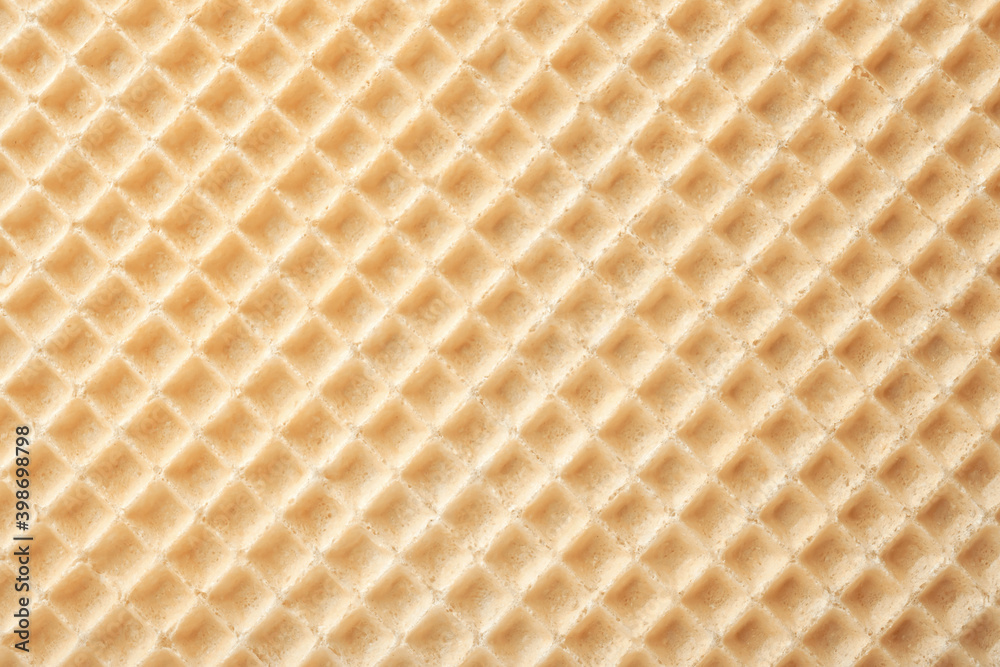 Empty wafer texture as background. Closeup view of golden waffle. Top view Empty wafer texture as background. Closeup view of golden waffle. Top view