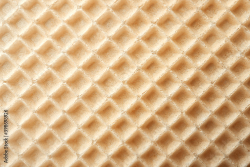 Empty wafer texture as background. Closeup view of golden waffle. Top view