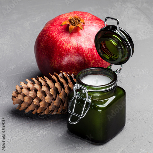 Postcard Merry Christmas and Happy New Year Composition of elements with Christmas decorations, candle, cone, pomegranate photo